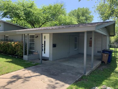 View of front of home featuring brick siding, a f