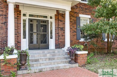 Very inviting front porch with screened doors to t