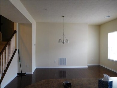 dining area features hardwood flooring and doors t