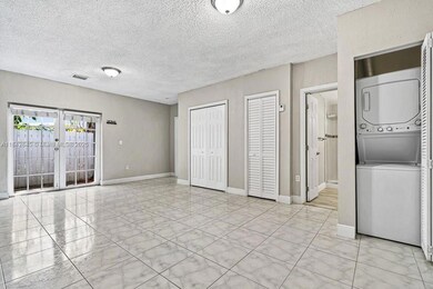 View of living room showcasing open flow to dining and kitchen, includes washer/dryer.