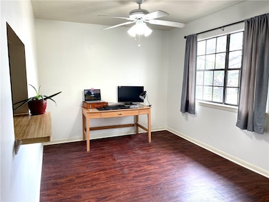 Office space with a ceiling fan, wood finished flo