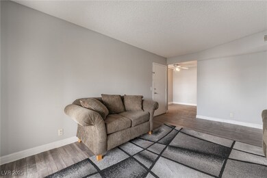 Living room featuring wood finished floors, a text