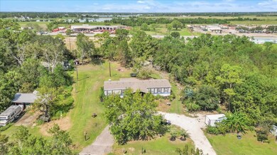 Open yard area surrounded by trees with a 