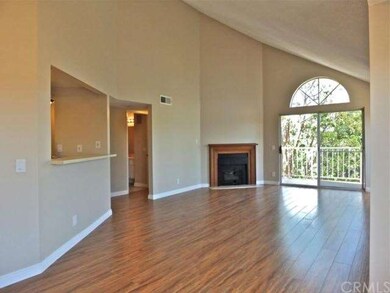 The living room's vaulted ceiling, gas fireplace, 