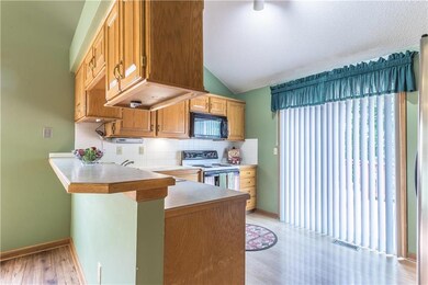 The kitchen has lots of cabinets and a new slider 
