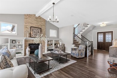 Living room with dark wood-style flooring, beamed ceiling, stairs, high vaulted ceiling, and a chandelier
