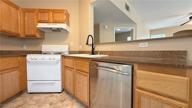 Kitchen featuring dishwasher, under cabinet range