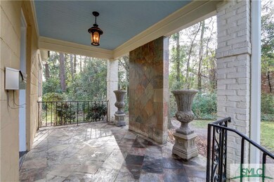 Wrought iron railings and stone tiled front porch.