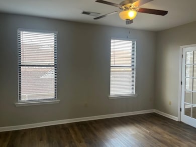 Unfurnished room with dark hardwood / wood-style f