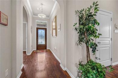 Entrance foyer featuring dark wood-style floors, a