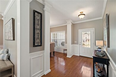 Entryway features hardwood floors, lots of wood mo