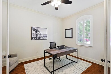 Home office with french doors, ceiling fan, dark h