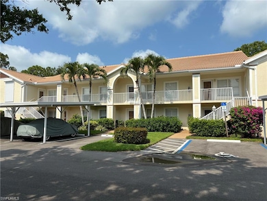 View of building exterior featuring covered and un