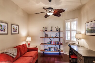 Expansive den has wood flooring and ample space to
