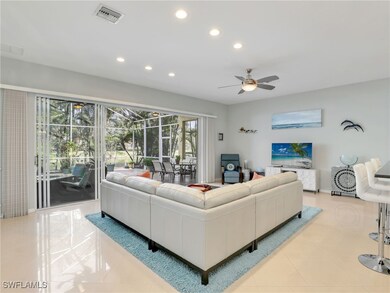 Tiled living room featuring ceiling fan