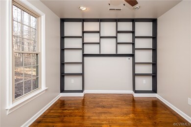 First floor Bedroom featuring dark wood flooring a