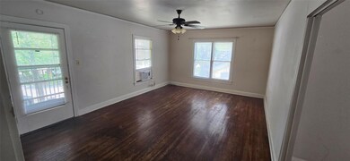 Unfurnished room with dark wood-style flooring, a