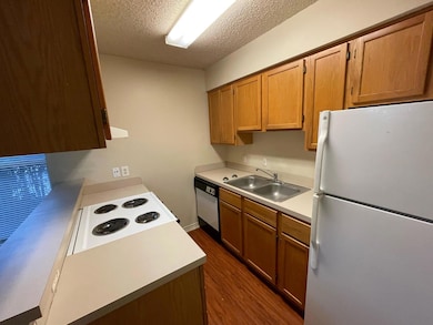 Kitchen with freestanding refrigerator, dark wood
