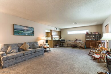 Carpeted living room featuring a textured ceiling