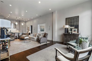 Living area featuring wood finished floors and recessed lighting