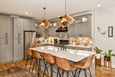 The renovated kitchen with stainless steel appliances and ample storage is a perfect blend of mountain rustic and clean contemporary.