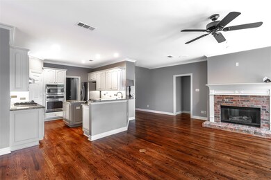 Kitchen featuring dark wood-type flooring, a kitch