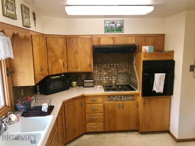 View to kitchen with cooktop and wall oven