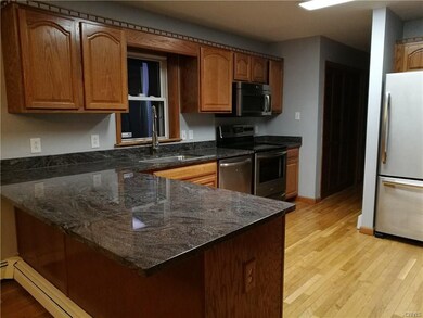 The kitchen features granite counters, stainless s