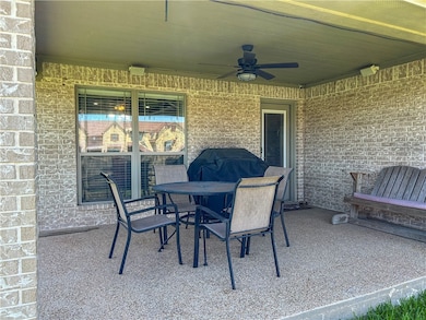 View of patio featuring a ceiling fan and outdoor