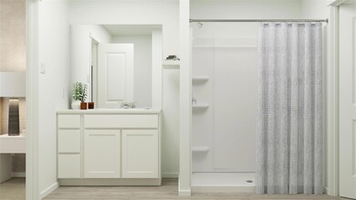Bathroom with a stall shower, wood finished floors