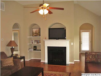 Vaulted ceilings, fireplace, and gleaming hardwood