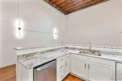 Kitchen featuring stainless steel dishwasher, ligh
