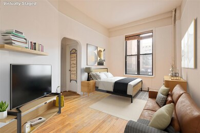 Bedroom featuring arched walkways and hardwood / wood-style flooring