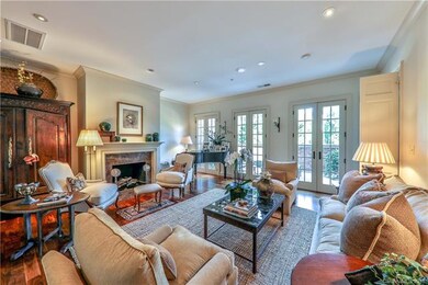 Family room with fireplace accesses private balcon