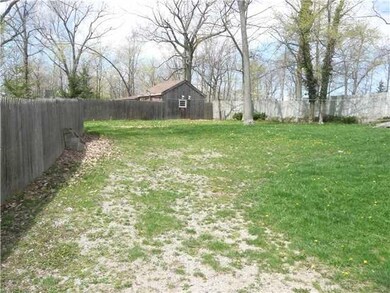 Exterior Back Barn/workshop beyond fence yard with more acreage
