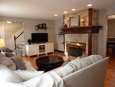 Family Room. Stacked stone faced fireplace is wood