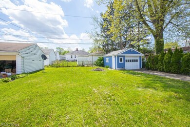 View of yard with a garage and an outdoor structure