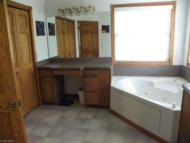 Master bath features a jacuzzi tub, make up counte
