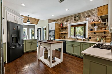 Kitchen featuring green cabinetry, black appliance
