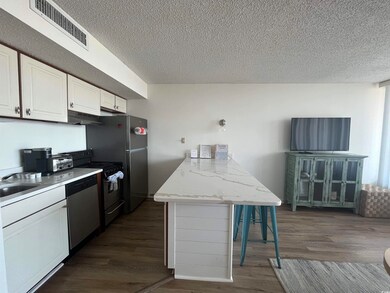 Kitchen with range, white cabinets, dark hardwood 