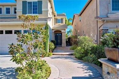 Lush landscaping with timeless hardscape to an inv