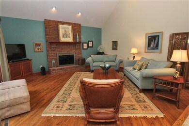 Family Room with Log Burning Fireplace & Hardwood 