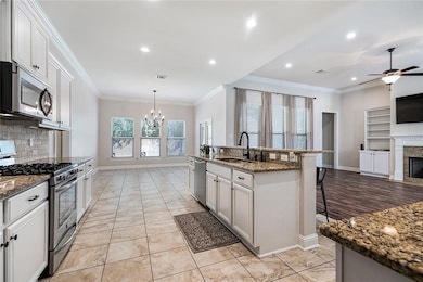 KITCHEN FEATURES STAINLESS APPLIANCES AND A GAS RA