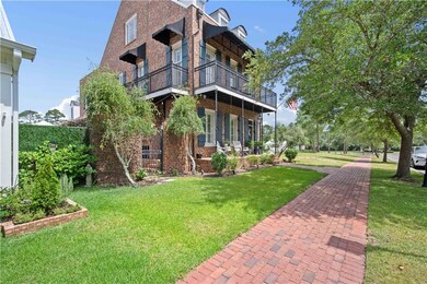View of home's exterior with brick siding, a lawn, and a balcony