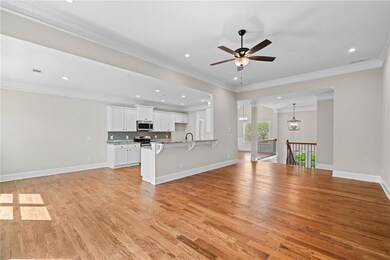 Unfurnished living room featuring ornamental moldi