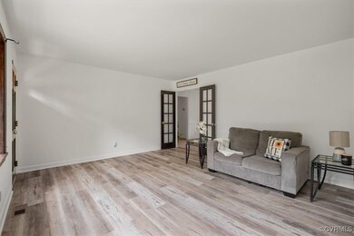 Living room featuring french doors and light hardw