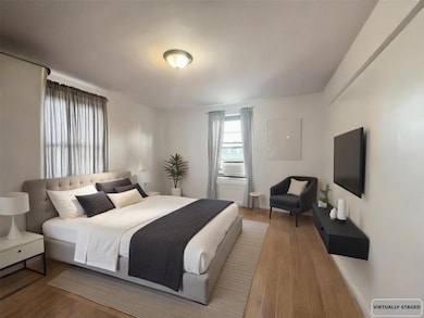 Bedroom with wood finished floors and baseboards