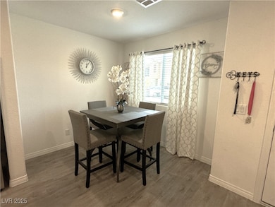 Dining room with baseboards and wood finished floo