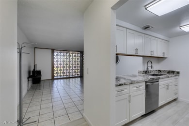 Kitchen with stainless steel dishwasher, a sink, w