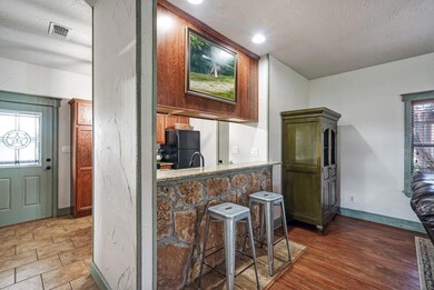 Kitchen with a kitchen breakfast bar, dark tile fl